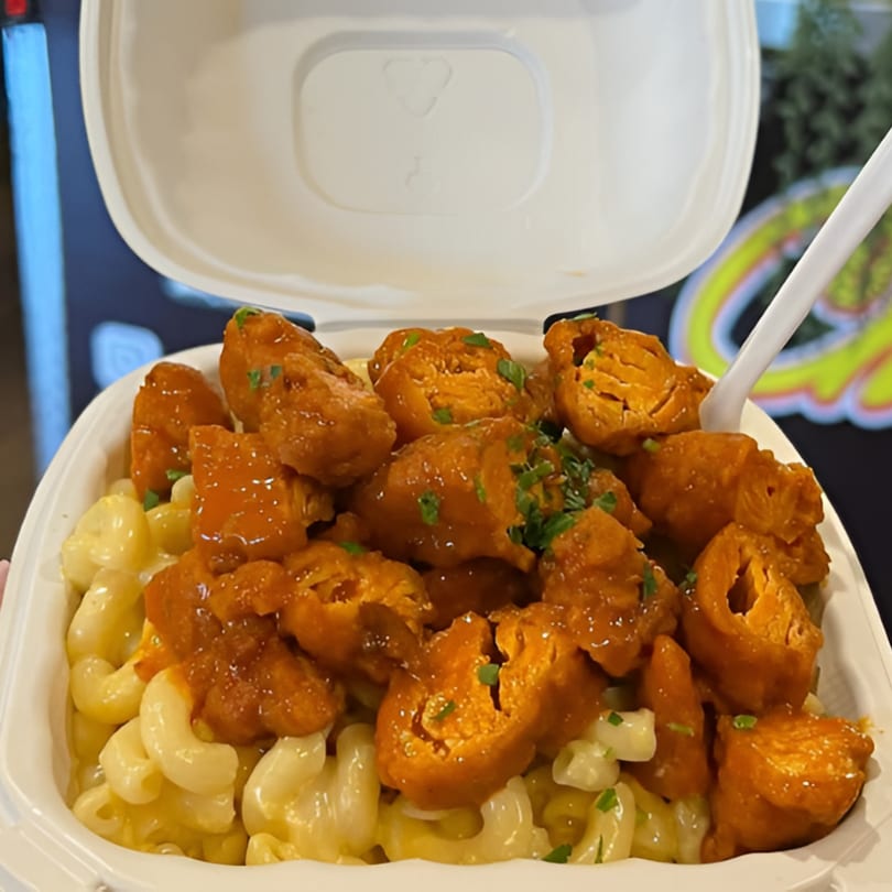Chick Wings and Things' boneless wings with buffalo sauce and chives over creamy macaroni and cheese.